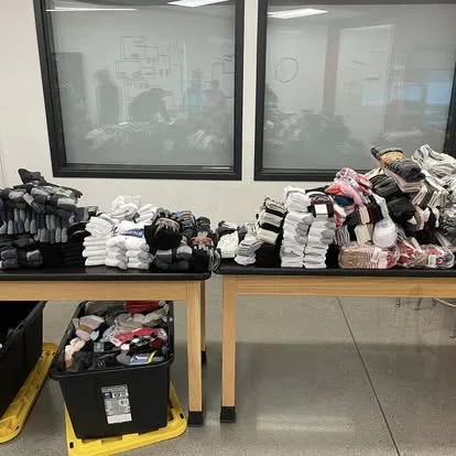 Socks sorted into stacks on two tables